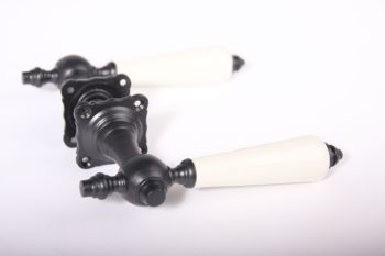 Door handle black cast iron pair with antique white porcelain and rosettes