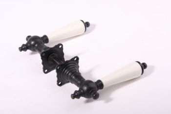 Door handles black cast iron with a porcelain spacer and two handle rosettes