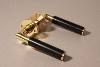 Door handle Bauhaus round brass polished with black ebony including rosettes per pair