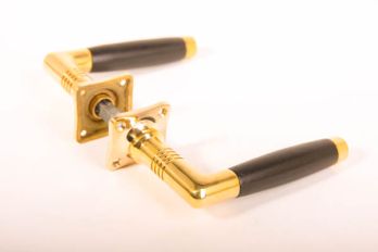Thirties door handle barrel model brass polished with ebony wood including rosettes