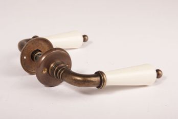 Door handle antique bronze with antique white porcelain including rosettes per pair